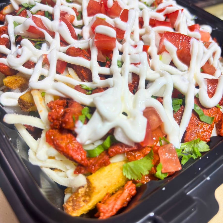 Asada Fries — crispy fries loaded with carne asada, pico de gallo and crema
